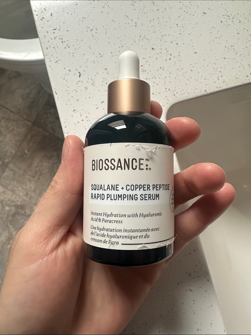 Biossance Squalane + Copper Peptide Serum in white and gold-topped bottle